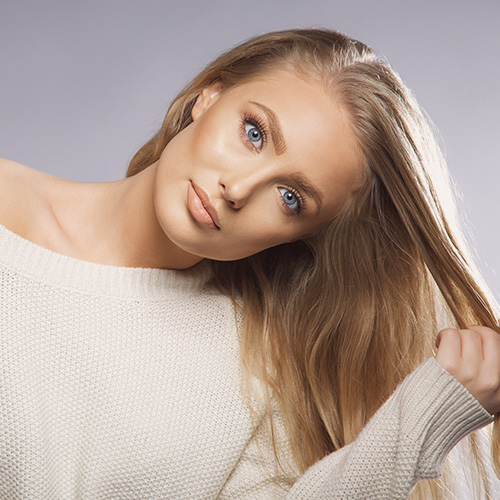 blonde woman running her hand through her hair