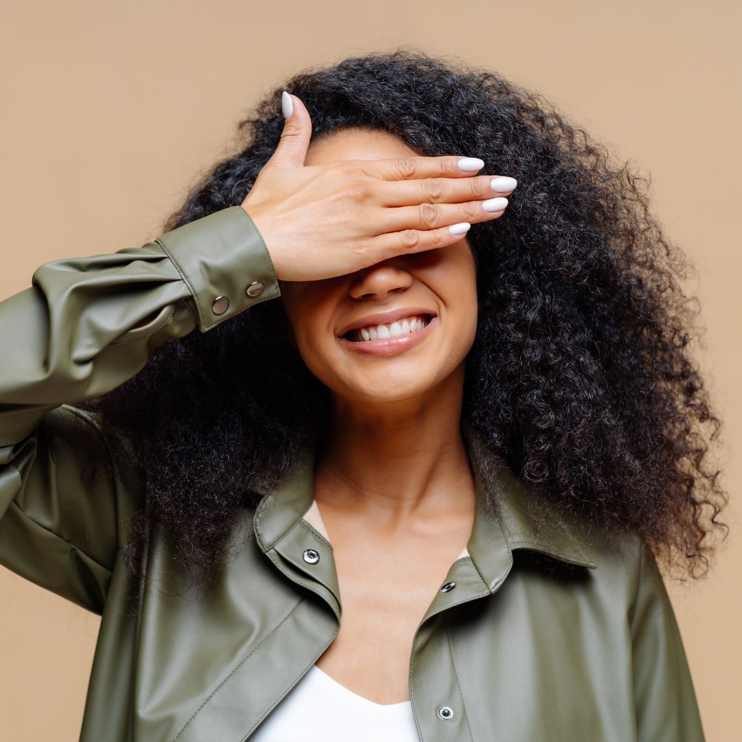 img of a woman covering her face