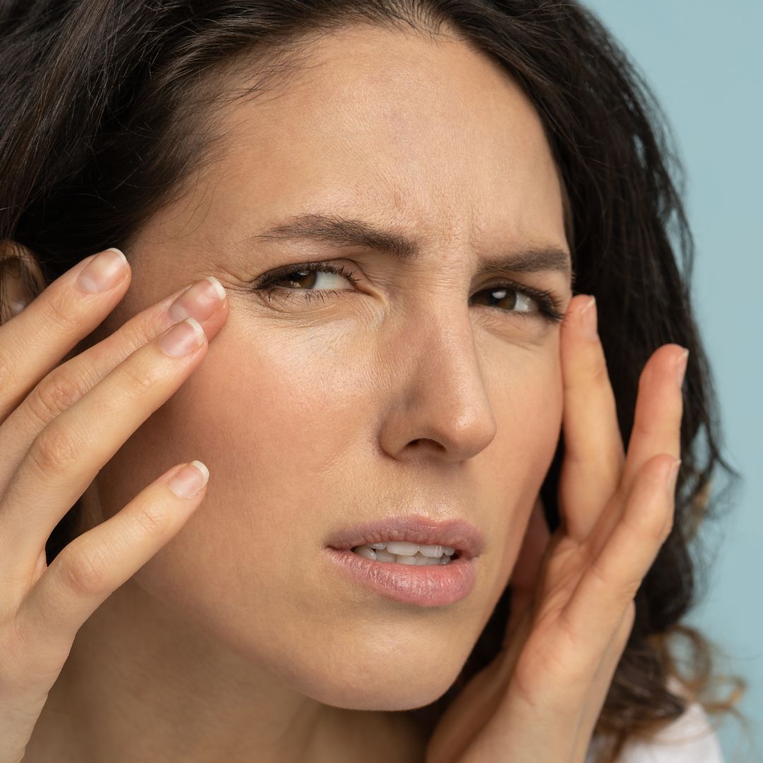 img of a woman looking at wrinkles