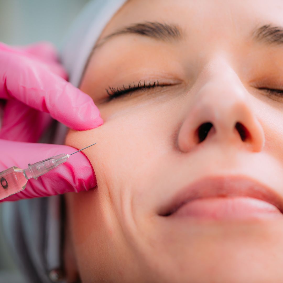 dermal filler being injected into a woman's cheek